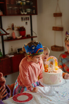 Blowing candles for fifth birthday