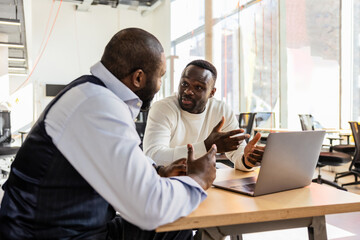 Two professionals engaged in a serious discussion at work