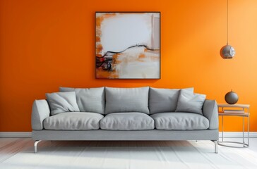 Modern grey sofa against vibrant orange wall with abstract art and decor