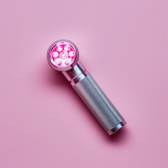 Tiny Flashlight on Pale Pink Background: Detailed Close-up