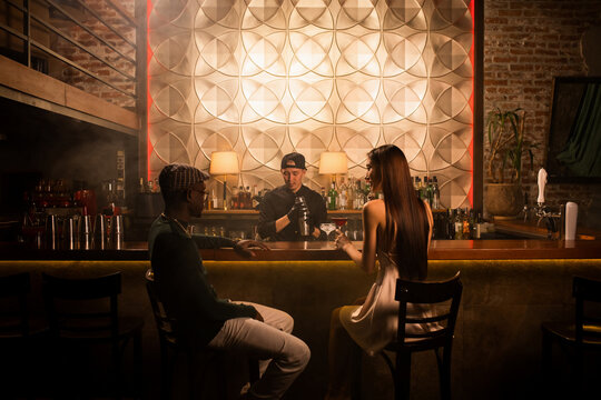 Guests at the bar waiting for cocktails