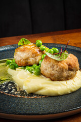 mashed potato with meatballs and peas