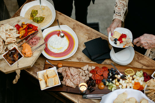 Elderly Woman Making Charcuterie Plate
