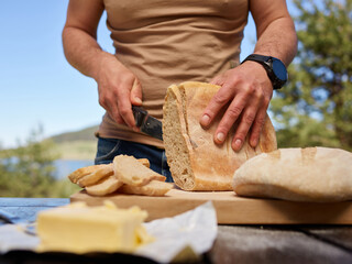 Man cutting freshly baked bread