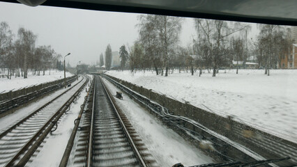 The train runs through the city. City electric train. A subway train goes outside.