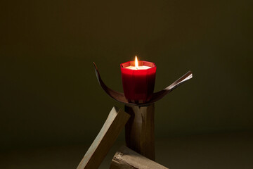 Burning candles and air brick on table
