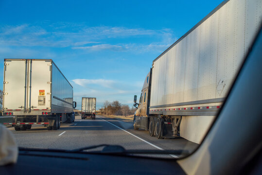 Three trailer trucks on highway road
