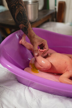 Baby pooping during bathing.