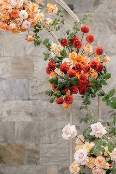 Floral Arch Decorated With Orange and Red Roses and Dahlias