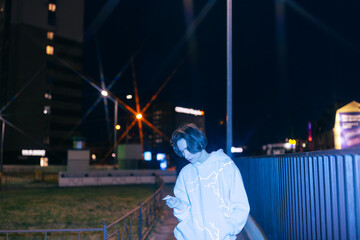 Non binary person on the street, smoking 