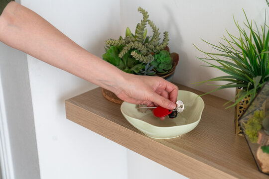 Hand Placing Keys in Bowl