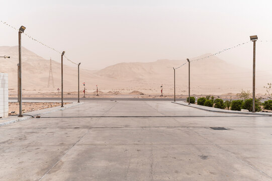 Desert Landscape and Road Entrance with Streetlights