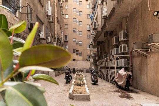 Urban alley with motorbikes and air conditioning units