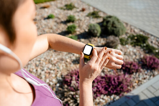 A woman uses an electronic watch