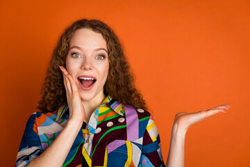 Photo of lovely adorable girl wear stylish print clothes arm face introduce offer empty space...