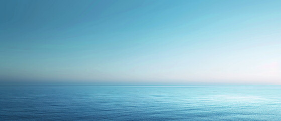 Serene view of the blue ocean meeting the sky at dawn, creating a tranquil and peaceful atmosphere.
