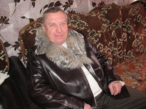 an elderly man is sitting on a sofa