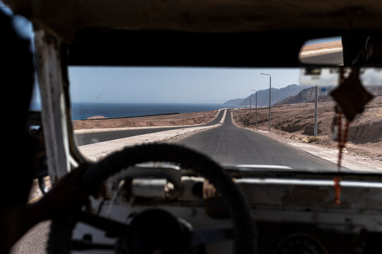 View from inside a car on a coastal road in summer