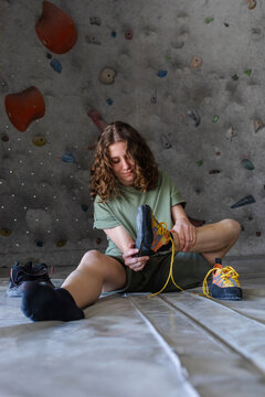 Climber Tying Shoelaces on Climbing Shoes