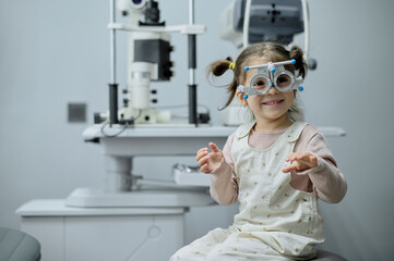 Little girl checking up her sight at ophthalmology center