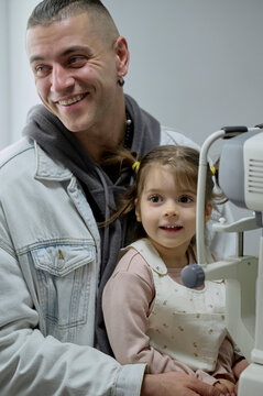 Dad with daughter in ophthalmology clinic