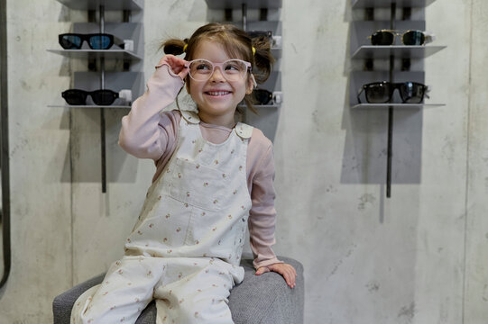 little girl with glasses in optical store