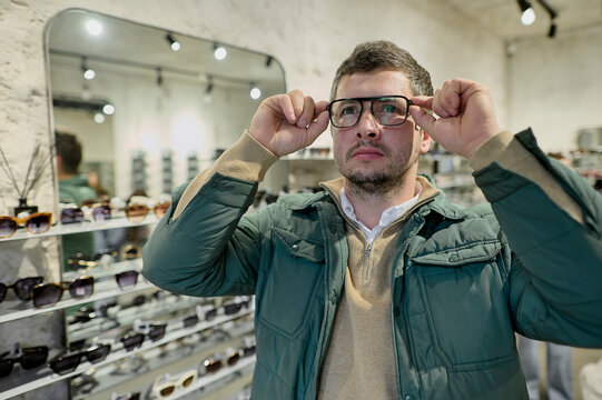 Man picking frame for vision correction