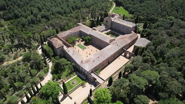 Orbital drone footage of Fontfroide Abbey on sunny day. Narbonne, France.