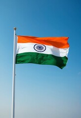 Naklejka premium The majestic national flag of India flutters against the clear sky. Indian Independence Day.