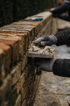 Mason laying bricks with precision