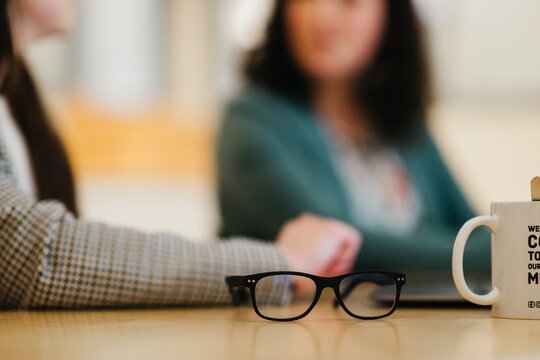 Focused work environment with mugs and spectacles - meeting