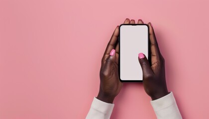 Black woman's hands holding an iPhone on a pink background with matching nail polish