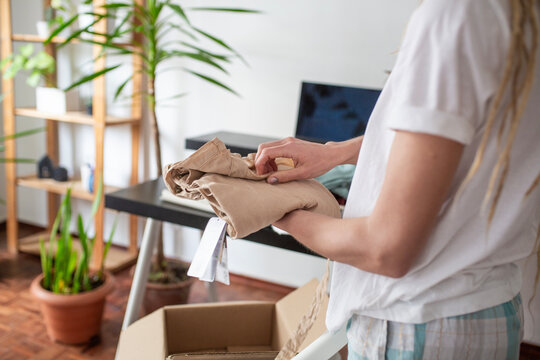 woman recieve delivery package from clothes online shop 