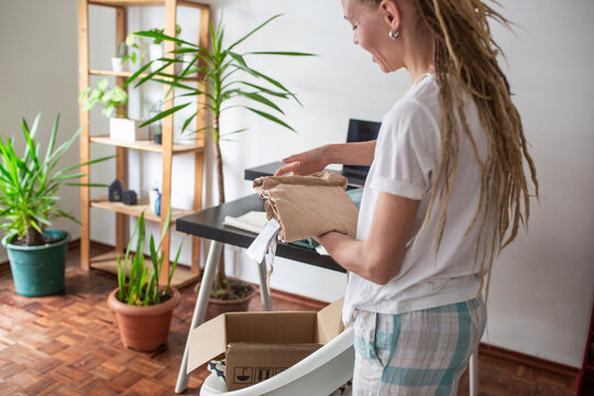 woman recieve delivery package from clothes online shop 