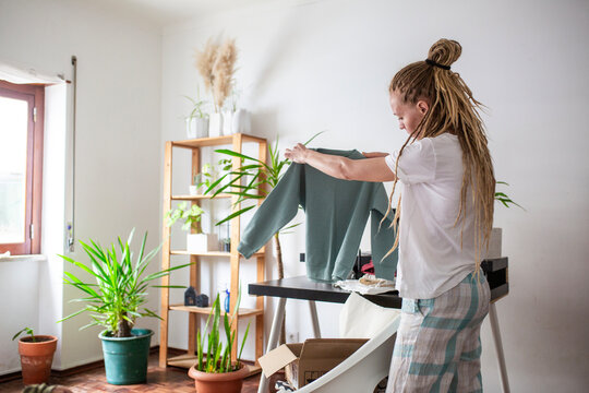 woman recieve delivery package from clothes online shop 
