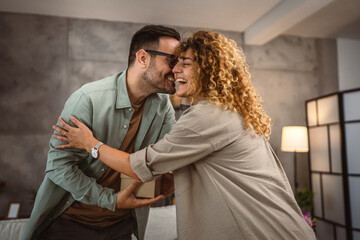 Boyfriend hug her girlfriend and hold birthday gift