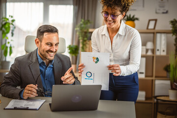 Man and woman colleagues have a video call consultation at office