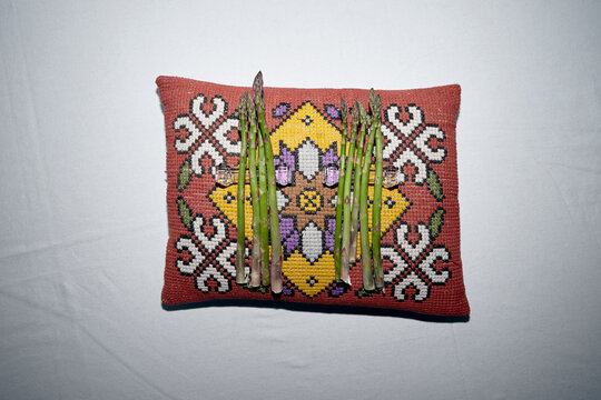 Asparagus on an embroidered pillow