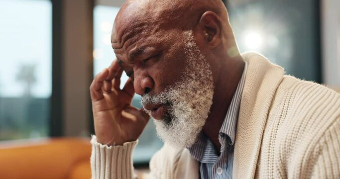 Black man, retired and headache in living room with stress, pain or brain aneurysm at home. Emergency, health or elderly male person with migraine from condition, anxiety or hurt in lounge or tension