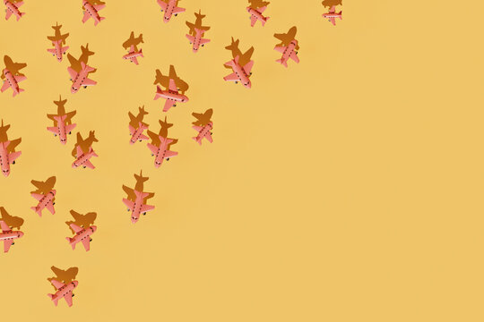 Evenly Distributed Pink Paper Airplanes on Yellow Background