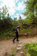 Obraz premium Climber Hiking up the Mountain Trail
