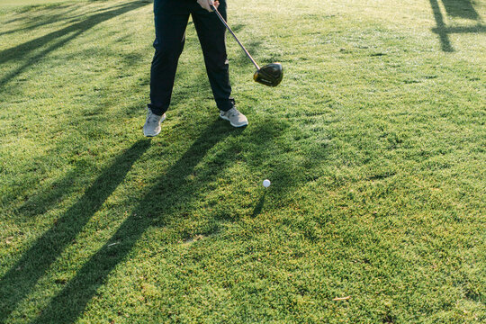 Close up of legs of young man playing golf 