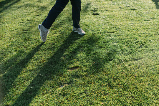 Close up of legs of young man playing golf 