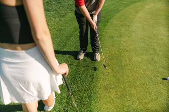  young couple  playing golf in the morning sun 