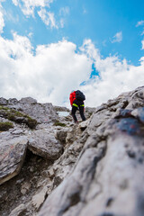 Hiker Walking Up a RockyMountain Trail Up to the Summit