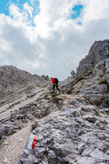 Equipped Hiker Hiking Along a Rocky Mountain Trail to the Summit