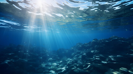 Obraz premium Blue sunlight filtering through the underwater sea