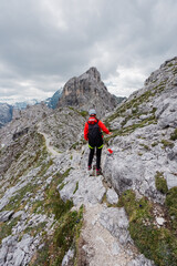 Hiker Walking on a Mountain Ridge in an Alpine High Altitude Landscape