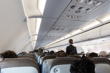 Passengers seated in airplane cabin