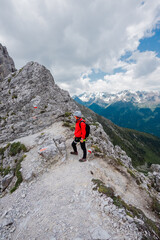 Hiker with Helmet Standing on a High Altituede Mountain Trail